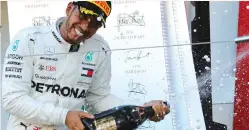  ?? (Toru Hanai/Reuters) ?? LEWIS HAMILTON celebrates a win earlier this month.