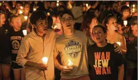  ?? JASON LAPPA / NEW YORK TIMES ?? Thousands of people gather Wednesday at the University of Virginia in Charlottes­ville for a candleligh­t vigil after the previous weekend’s violence. The crowd sang hymns, gospel songs and other anthems of belonging.