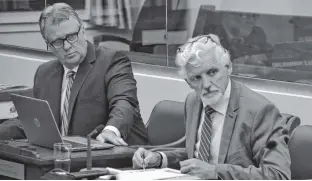  ?? STU NEATBY/THE GUARDIAN ?? Holland College president Sandy MacDonald, right, and vice-president corporate services Doug Currie take questions from MLAs during a standing committee at the Coles Building on Tuesday. MacDonald referred to the growing shortage of workers in P.E.I. as “a little alarming.”