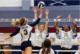  ?? Jason Fochtman ?? College Park’s Lauren Freeman (3) tips the ball against Conroe blockers Brooke Bartlett (11) and Victoria Ratcliff (15) during the first set of a District 12-6A high school volleyball match Tuesday at College Park High School.