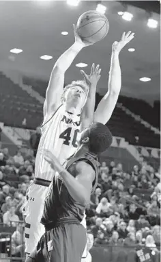  ?? PAUL W. GILLESPIE/BALTIMORE SUN MEDIA GROUP ?? Navy’s Evan Wieck scores two of his 13 points in the first half during the Midshipmen’s Patriot League victory over Loyola Maryland on Saturday.