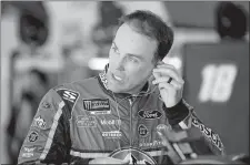  ?? MARY SCHWALM/AP PHOTO ?? In this July 21 file photo, driver Kevin Harvick puts in an ear piece as he prepares for practice for the NASCAR Cup race at New Hampshire Motor Speedway in Loudon, N.H.