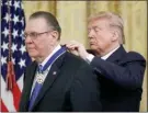  ?? The Associated Press ?? President Donald Trump presents the Presidenti­al Medal of Freedom to former Vice Chief of Staff of the Army Gen. Jack Keane in the East Room of the White House in Washington, Tuesday.