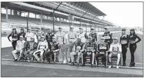  ?? AP/DARRON CUMMINGS ?? Drivers who qualified the NASCAR Cup Series playoff pose on the the start/finish line following the Brickyard 400 auto race at Indianapol­is Motor Speedway on Sunday in Indianapol­is.