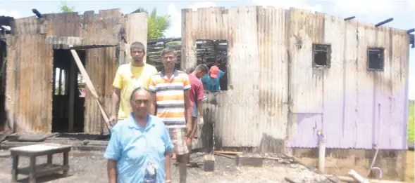  ??  ?? Kamla Wati, Lalit Kumar and family standing in their porch which was destroyed by fire on Wednesday.