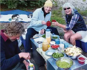  ??  ?? The hikers enjoying margaritas made from mountain snow at the base camp.