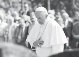  ??  ?? Pope Francis prays silently yesterday in tribute to 1.5 million people, most of them Jews, gassed there by Nazi occupiers during World War Two AFP