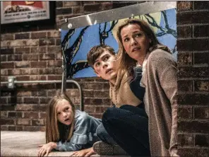  ??  ?? Hutch Mansell’s daughter Abby (Paisley Cadorath), son Blake (Gage Munroe) and wife Becca (Connie Nielsen) have no idea what he’s capable of in “Nobody.”