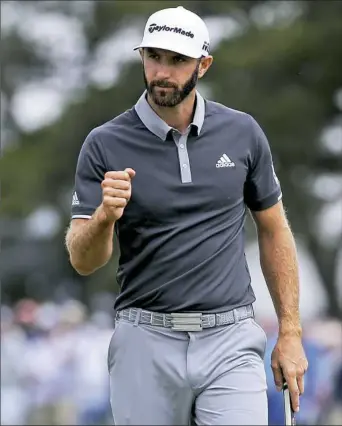  ?? Seth Wenig/Associated Press ?? Dustin Johnson reacts after making a putt for birdie on the fourth green in the second round of the U.S. Open. His 3-under 67 put him four shots clear of the field.