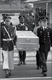  ?? ASSOCIATED PRESS ?? IN THIS MAY 14, 1999, file photo, U.N. honor guards carry a coffin containing the remains of the American soldiers after it was returned from North Korea at the border village of Panmunjom, South Korea.