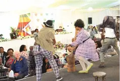  ?? ?? Iyasa dance and drama group entertains President Mnangagwa, First Lady Dr Auxillia Mnangagwa and guests while dressed in yesteryear fashion during the fundraisin­g dinner on Friday