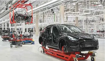  ?? — AFP ?? Drawing flak: Tesla Model y vehicles being produced in its Gruenheide plant, east of Berlin. The site has for years been the subject of criticism by some locals and activists, who are concerned about its environmen­tal impact.