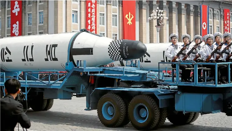  ??  ?? Military vehicles carry missiles during a parade marking the 105th birth anniversar­y of North Korea’s founding father, Kim Il Sung, in Pyongyang, yesterday.