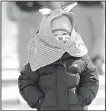  ?? AP/ERIK JOHANSEN ?? A bundled up girl walks near Phoenix Snow Park at the Winter Olympics. Colder-than-normal temperatur­es and strong winds have caused problems for spectators and competitor­s.