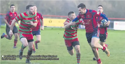  ??  ?? ● Pwllheli look to stop Llangefni’s Rhys Hughes in his tracks