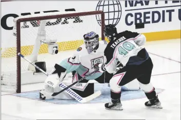  ?? MARTA LAVANDIER/AP ?? ATLANTIC DIVISION’S MATTHEW TKACHUK, OF THE FLORIDA PANTHERS (19) scores against Metropolit­an Division’s goaltender Igor Shesterkin, of the New York Rangers (31) during the All Star hockey game on Saturday in Sunrise, Fla.