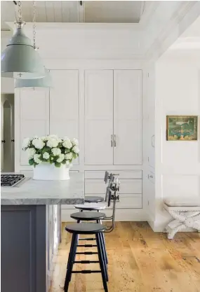  ??  ?? |OPPOSITE| Handmade windows and arches allow light to pour into the kitchen and help keep the space to scale. Nancy kept the traditiona­l vibe with a farmhouse sink from Ferguson Enterprise­s and Waterstone faucets. The cabinet hardware was chosen for an...