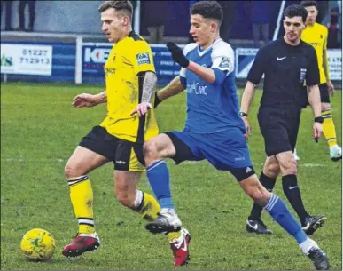  ?? Picture: Chris Davey FM5034229 ?? Faversham’s Danny Walder tracked by Herne Bay during the Boxing Day clash