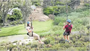  ??  ?? SA WINNERS: Kirkwood High pupils Miké Hechter and Yandré Tibshraeny enjoyed one of the Eastern Cape’s fun tourism activities when they went zip-lining at Adrenalin Addo