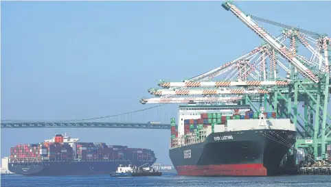  ??  ?? A cargo chip, left, arrives into the Port of Los Angeles after departing from the Port of Yantian, China on Thursday in San Pedro, California.