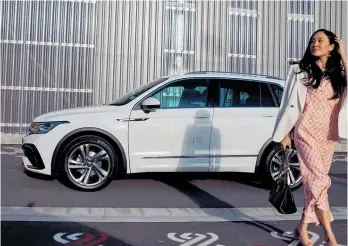 ?? ?? Trish Peng says she loves the way the colour of her Volkswagen Tiguan captures the style of her bridal store; parking assist is life-changing for tiny spaces in Auckland city (below).