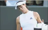  ?? Ben Curtis / Associated Press ?? Garbine Muguruza leaves the court after losing to Alison Van Uytvanck at Wimbledon Thursday.