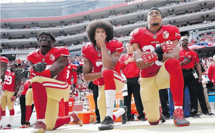  ?? — THE ASSOCIATED PRESS FILES ?? Last season’s anthem protest led by quarterbac­k Colin Kaepernick, centre, is a considerat­ion for any team signing him, according to NFL executives.