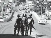  ?? Fernando Antonio Associated Press ?? HONDURAN soldiers at a Tegucigalp­a checkpoint during unrest over the disputed presidenti­al election.