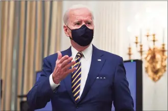  ?? Nicholas Kamm / AFP via Getty Images ?? President Joe Biden speaks about the COVID-19 response before signing executive orders for economic relief Friday in the State Dining Room of the White House in Washington.