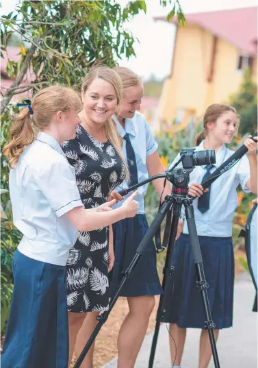  ??  ?? Coomera Anglican College students with film festival co-ordinator Sarah Hands set up equipment.