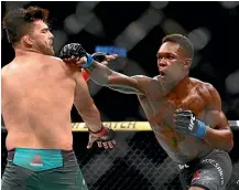  ?? AP ?? Israel Adesanya on the way to capturing the interim middleweig­ht title against Kelvin Gastelum.