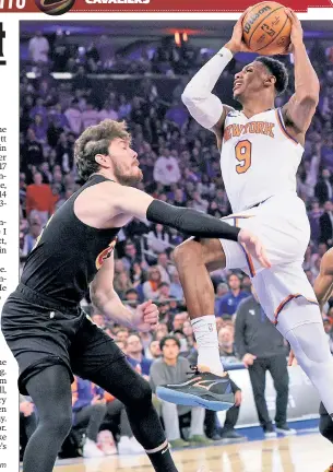  ?? ?? DRIVE THROUGH: RJ Barrett, who finished with 19 points and eight rebounds, drives to the basket against Cedi Osman (left) during the first quarter.