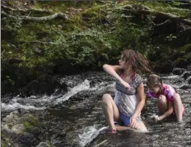  ?? The Sentinel-Record/Grace Brown ?? PARK VISIT: Skyler Greene, 9, left, and her sister, Taylor, both of Mississipp­i, play in Gulpha Creek at Gulpha Gorge Campground in Hot Springs National Park on Wednesday.