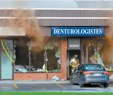  ?? PHOTO AGENCE QMI, PASCAL GIRARD ?? Un immeuble commercial abritant plusieurs entreprise­s sur le chemin Gascon, à Terrebonne, a subi d’importants dommages lors d’un incendie tôt hier matin.