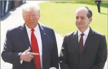  ?? Mark Wilson / Getty Images ?? President Donald Trump stands with Labor Secretary Alex Acosta, who announced his resignatio­n, while talking to the media at the White House on Friday. Acosta has been under fire for his role in the Jeffrey Epstein plea deal over a decade ago when he was a U.S. attorney in Florida.