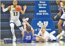  ?? STAFF PHOTO BY MATT HAMILTON ?? UTC’s Malachi Smith (13) reaches to steal an errant pass by North Georgia’s Frank Champion (23), alongside UTC’s Jaden Frazier on the floor at McKenzie Arena on Saturday afternoon. The Mocs defeated North Georgia 81-63, improving to 6-0 depsite playing without fifthyear senior guard and leading scorer David Jean-Baptiste, who has put his name in the NCAA transfer portal.