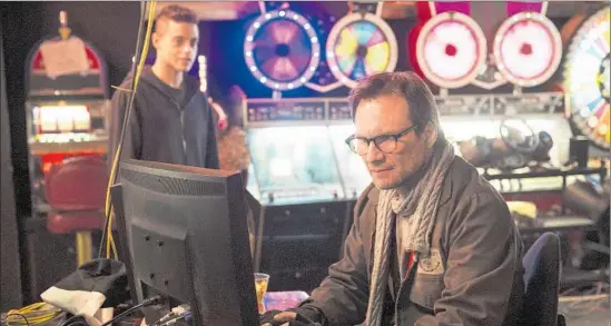  ?? David Giesbrecht USA Network ?? CHRISTIAN SLATER, right, stars as power-mad Mr. Robot, who is trying to recruit troubled cyber-security engineer Elliot (RamiMalek) to aid in his global plot.