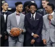  ?? FRANK FRANKLIN II — THE ASSOCIATED PRESS ?? Markelle Fultz, holding the ball to the left, De’Aaron Fox and Donovan Mitchell, right, gather with other draft prospects on stage for a group photo of prospects before the NBA Draft Thursday night in Brooklyn.