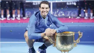  ??  ?? Rafa Nadal poses with his China Open trophy after he outclassed Nick Kyrgios 6-2, 6-1 in the final in Beijing on October 8, 2017. GETTY IMAGES