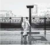  ?? GIULIA MARCHI/THE NEW YORK TIMES ?? A worker sprays disinfecta­nt at a rail station in Beijing. Scattered cases of the virus have appeared in Europe.