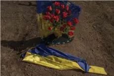  ?? ?? A Ukrainian flag on a grave of a victim of the Russian strike that hit a cafe last year, at a cemetery in the village of Groza, Kharkiv region, amid the Russian invasion of Ukraine.