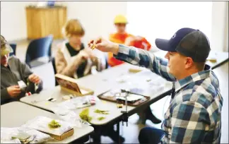  ?? Photo courtesy Morgan Schaufele ?? Andrew Beaton of the Oldman River chapter of Trout Unlimited Canada teaches fly-tying to local students. Trout Unlimited Canada wants to hold more educationa­l seminars in Lethbridge and area this year.