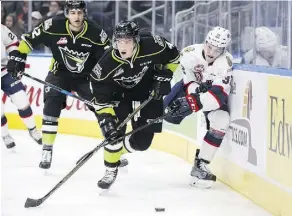  ?? CODIE MCLACHLAN/GETTY IMAGES ?? The Oil Kings’ Will Warm fights off the Regina Pats’ Robbie Holmes as he moves the puck up the ice Sunday during their WHL game at Rogers Place. The Pats were 5-3 winners.