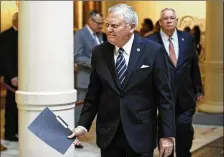  ?? BOB ANDRES / BANDRES@ AJC.COM ?? Gov. Nathan Deal, followed by House Speaker David Ralston, heads to a news conference where legislativ­e leaders announced Tuesday how they will deal with the tax windfall.