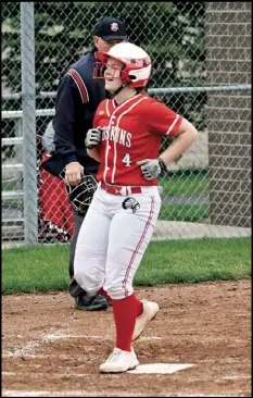  ?? Photos by John Zwez ?? Above left, Wapakoneta’s Emily Vanhorn throws the ball to first base in the Redskins 16-0 home win over definance
Wednesday. Above right, Carlie Schroeder crosses home plate in Wednesday’s win.