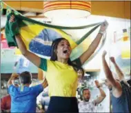  ?? MICHAEL DWYER — THE ASSOCIATED PRESS ?? Minele Freitas celebrates a Brazil goal while watching the World Cup soccer game against Costa Rica at a cafe in Framingham, Mass., Friday. Brazil defeated Costa Rica 2-0.