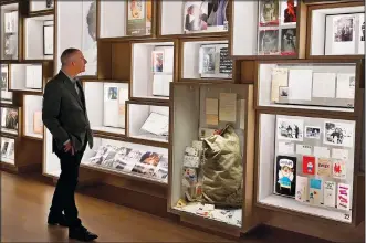  ?? (AP/Sue Ogrocki) ?? Steven Jenkins, director of the Bob Dylan Center and archive, looks at the archive wall Thursday at the center.