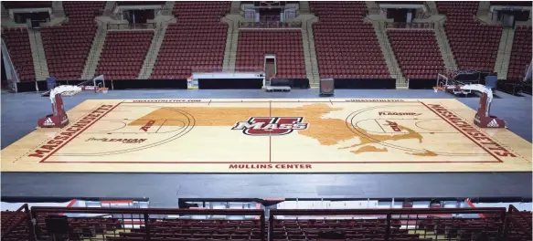  ??  ?? A giant outline of the state of Massachuse­tts covers the basketball floor at UMass’ Mullins Center.