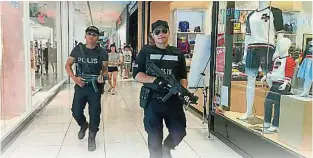  ??  ?? 柔州警方全副武裝，包括穿上防彈衣、持槍，在公共場所高調出巡。