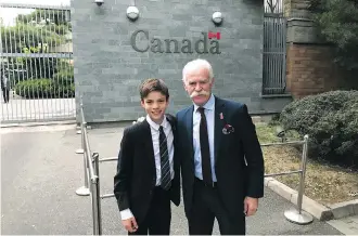  ??  ?? Flames legend Lanny McDonald and his grandson Hayden Townsley stand at the Canadian Embassy in Beijing.